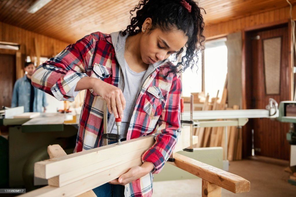 woman working on wood beam